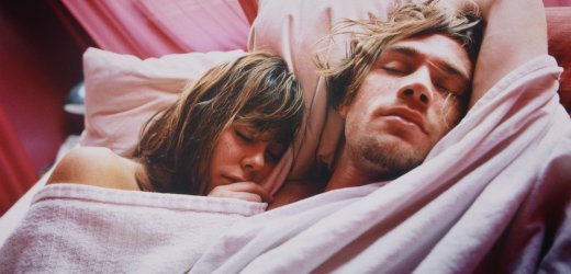 Young Couple Sleeping in Bed