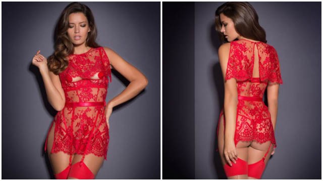 Honney may be sweet, but she certainly has a mischievous side. This fiery dress-up playsuit is made in all-over crimson red Leavers lace, with an underwired, peek-a-boo quarter cup bra, and a flirty detachable cape that buttons up at the nape and skims the tops of the cups to just cover the nipple. The bodice of the playsuit fits close to the body and features a side zip and a controlling wide elastic waistband with hook-and-eye fastenings, while the side-split skirt skims down over the hips from the waistband. Inner suspender ends are attached to the waist seam with soft satin elastic strapping. This style flatters all figures and is guaranteed to lead followers astray.  Honney is worn with a red trixie, sold separately.
