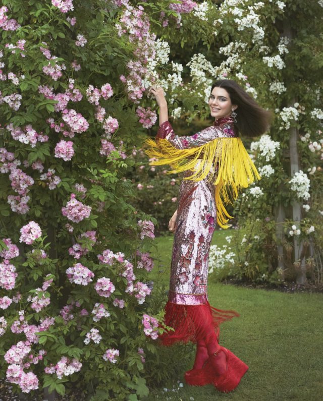 Posing in a garden, Kendall Jenner is all smiles wearing Gucci sequin embellished dress and boots