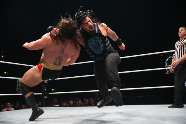 Roman Reigns rocks Rusev with a thunderous clothesline.
