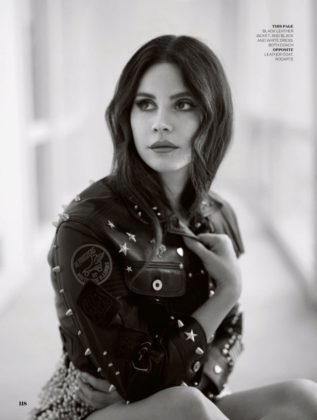Photographed in black and white, Lana Del Rey wears Coach embellished leather jacket and dress