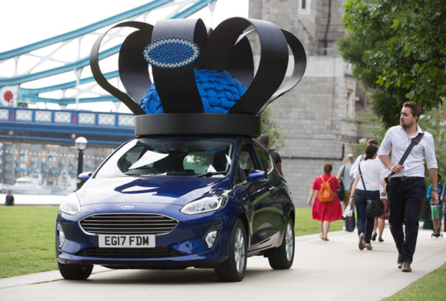Brand new 2017 Ford Fiesta (Mk VII), given a regal makeover by royal milliner Rosie Olivia, travels over Tower Bridge in London adorned with crown of Fiesta parts celebrating the car’s track record as UK’s favourite car since 2008