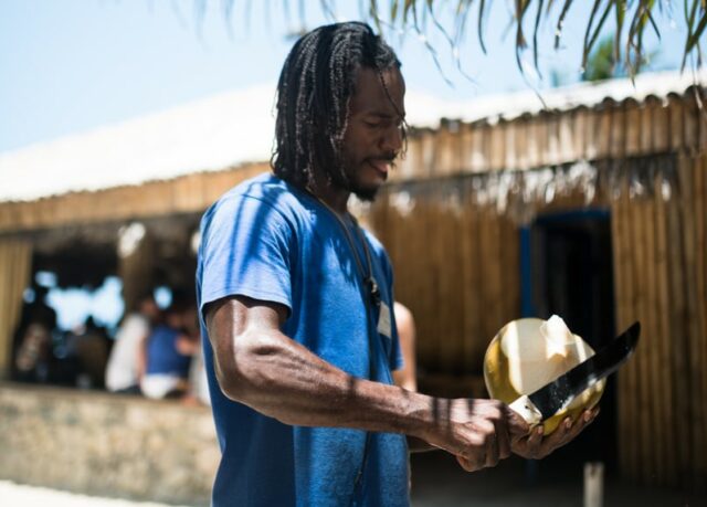 Yard Vibes – 5 insider’s tips for a fab Jamaican holiday man peeling coconut in Jamaica
