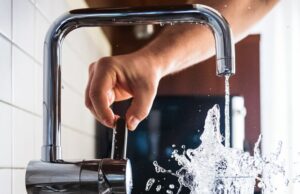 Dodgy Plumbing, Damp and Pests – Is Your Landlord Affecting Your Health? man opening a facet