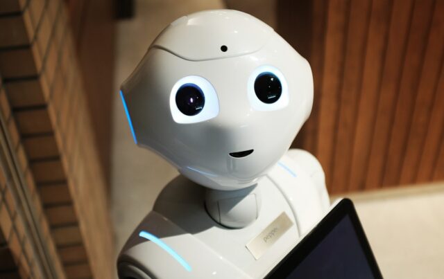 Will robots take my job? What do we fear most about the future of tech mini robot looking into a camera