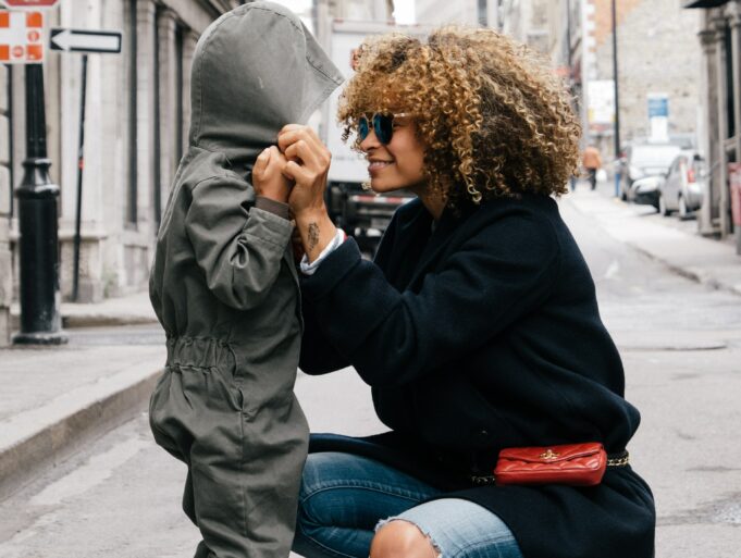 working parents woman holding kid at the street