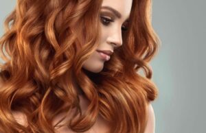 Beautiful model girl with long red curly hair .Red head . Care and beauty hair products