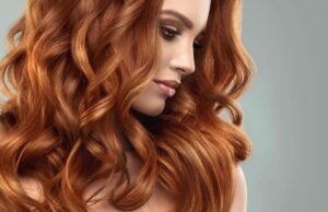 Myth or Proven? Does Rotating Your Shampoo Help Your Hair Texture? Beautiful model girl with long red curly hair .Red head . Care and beauty hair products