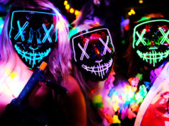 3 women wearing purge masks and fancy dress for Halloween