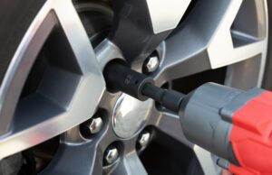 Photo of a wheels being screwed onto a vehicle