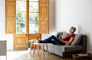 Garden Rooms: The Perfect Staycation A women relaxing on a large sofa