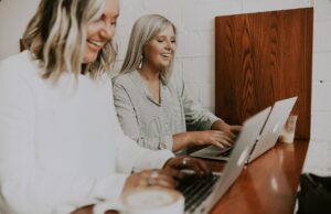 How to prepare for your financial future Two happy women using laptops