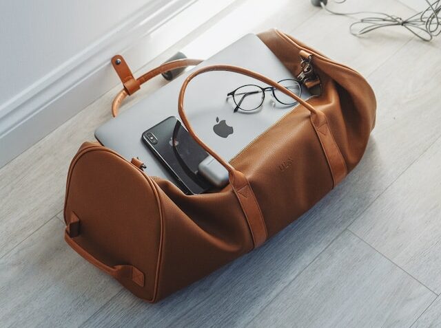 Photo of a travel bag with laptop and mobile phone