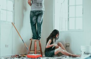 Photo of a man and women painting a room