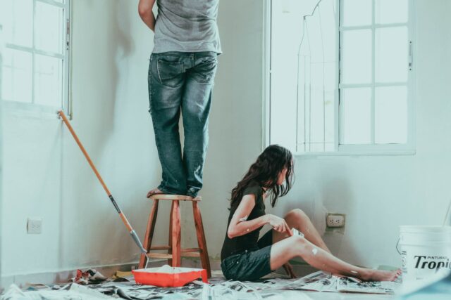 Photo of a man and women painting a room