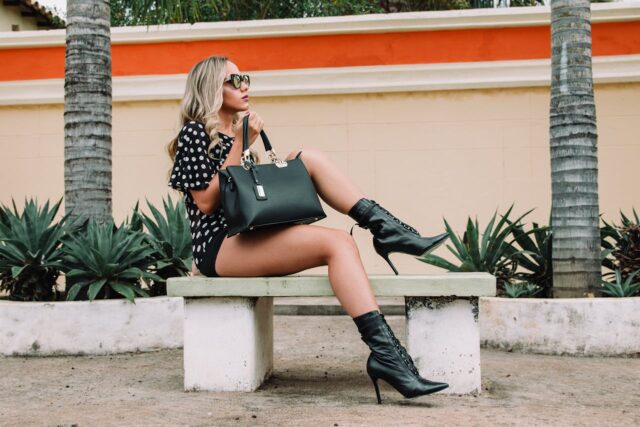 Photo of a fashionable lady sitting on a bench