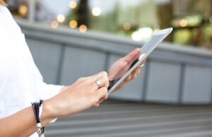 Tech on the Fly: Must-Have Gadgets for Business Travelers Women using a tablet pc