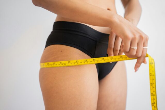 Is Using Collagen for Weight Loss a Safe Bet? topless woman with black panty and tape measure