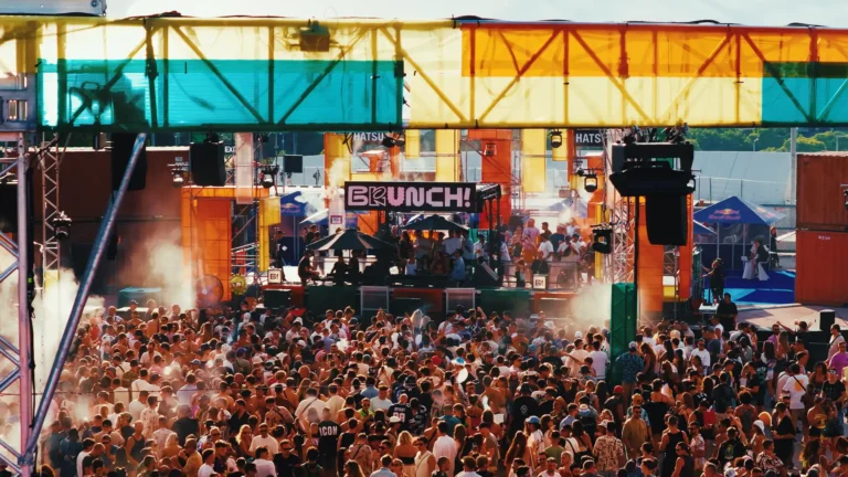 Outdoor festival crowd enjoying music in sunshine