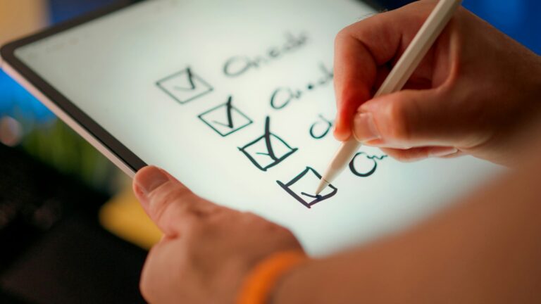 A hand marking off items on a check list