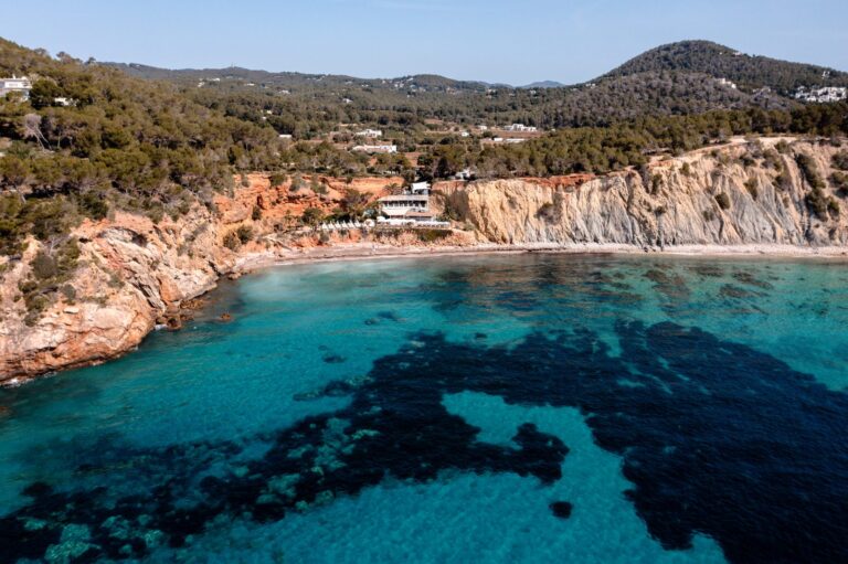 Aerial view of Sol d'en Serra Bay and the Amante Ibiza clifftop, Ibiza