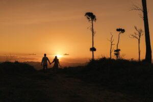 Couple holding hands at sunset