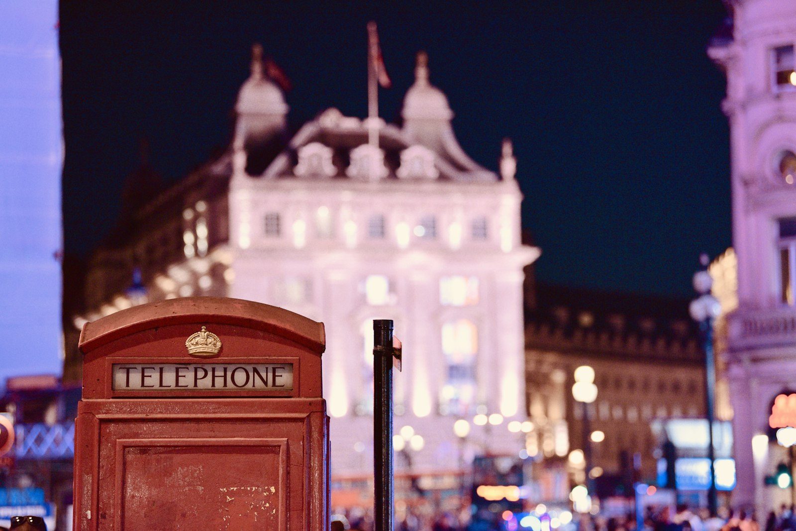 Red London telephone box at Piccadilly Circus at night