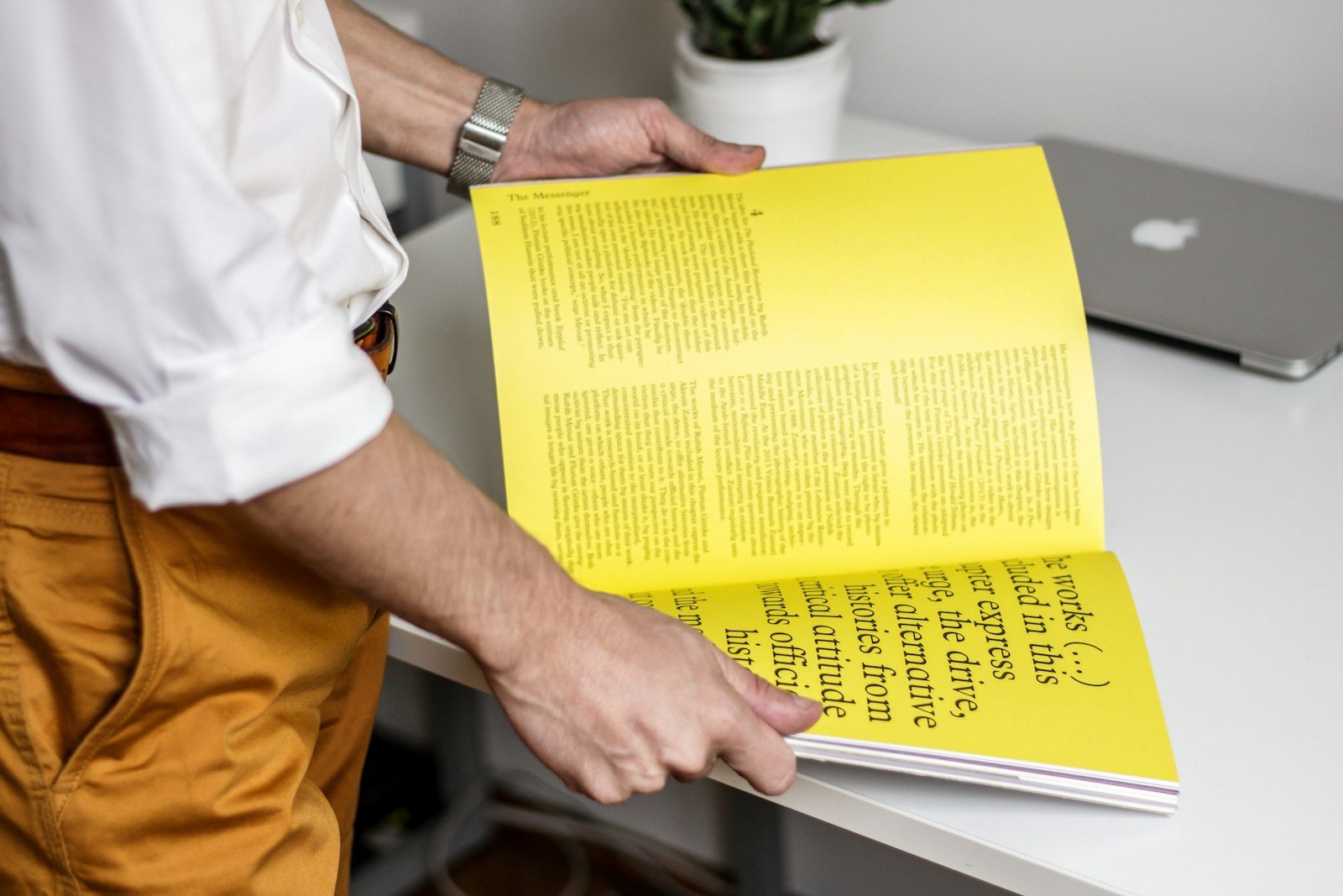 Reader holding a bright magazine spread