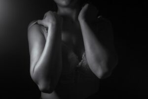 Close-up of a woman's shoulders and arms in shadow