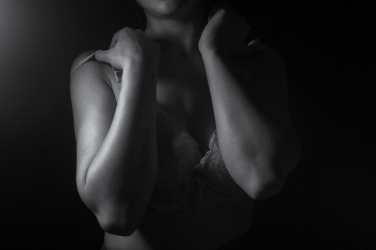 Close-up of a woman's shoulders and arms in shadow