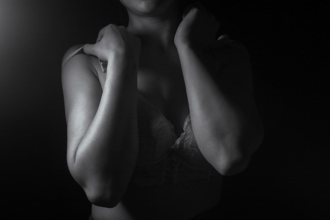Close-up of a woman's shoulders and arms in shadow