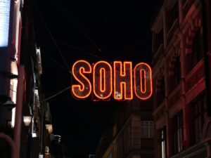 A neon sign hanging from the side of a building