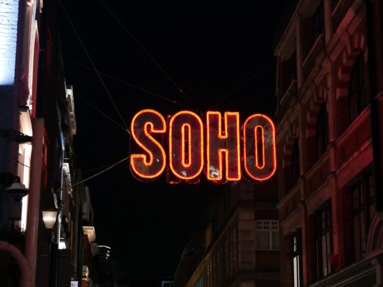 A neon sign hanging from the side of a building