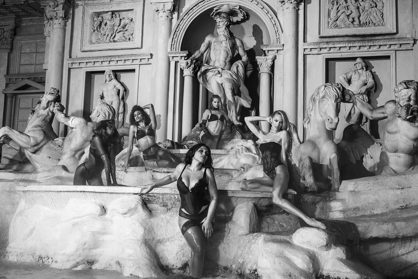 Model in black Victoria's Secret Very Sexy lingerie posed on the Trevi Fountain in Rome